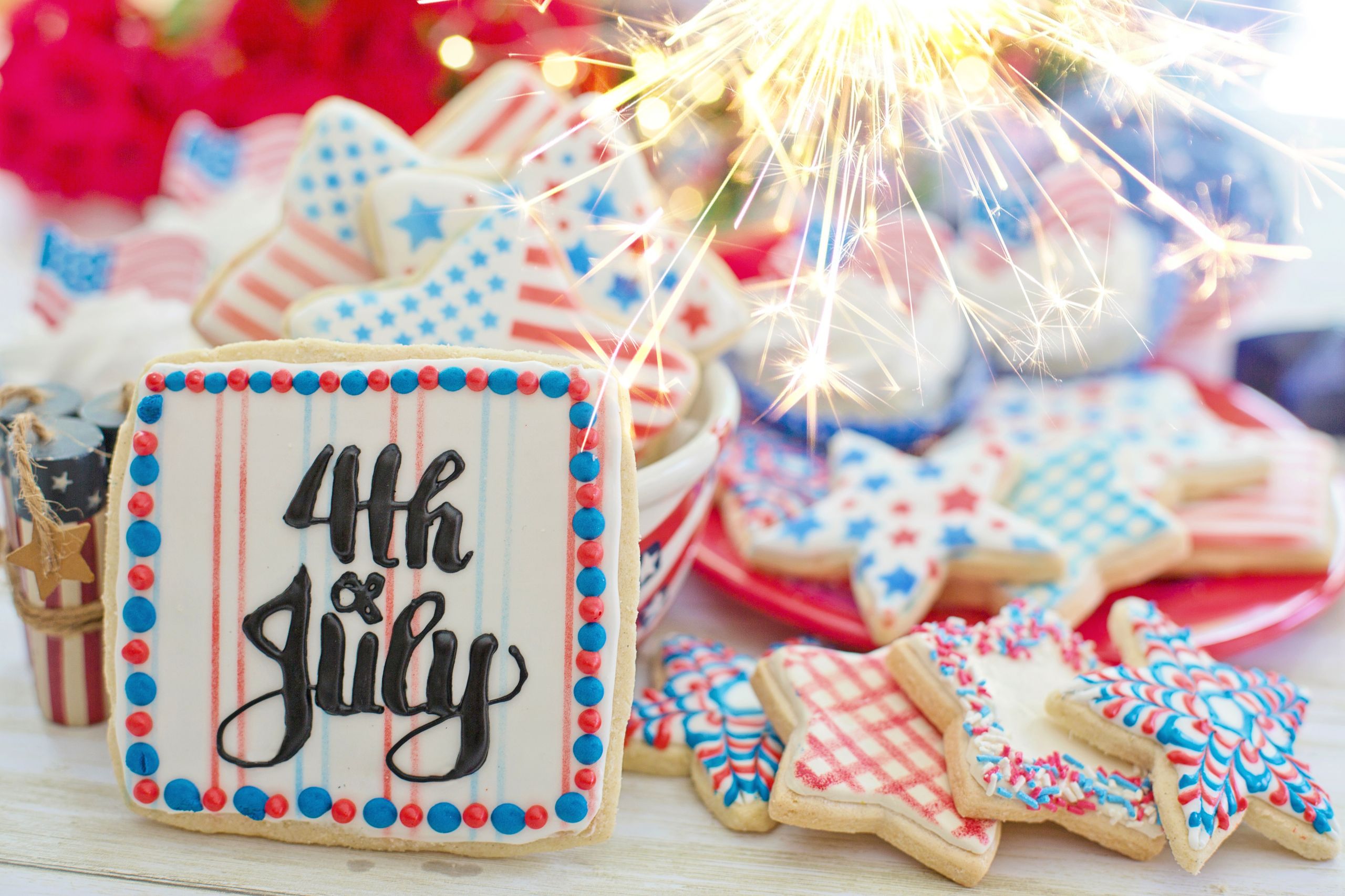 Indulge in patriotic 4th of July cookies with festive decorations and sparklers.