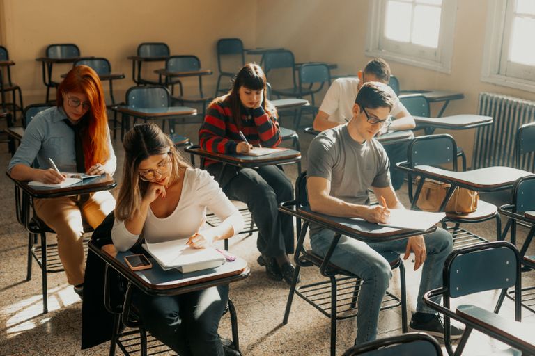 Students studying seriously in a Buenos Aires classroom setting during the day.