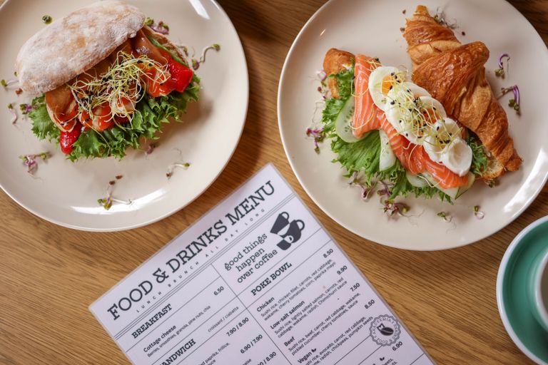 Tasty croissant sandwich with salmon and ciabatta with vegetables, perfect for a balanced meal.