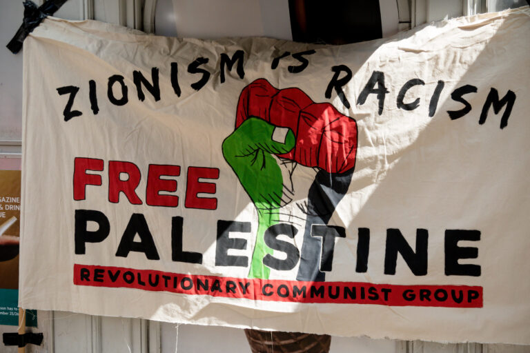 London, United Kingdom, 14th April 2018:- Banner at a gathering of protesters along Kensington High Street, near the Israeli Embassy in London to protest the ongoing occupation of Palestine.