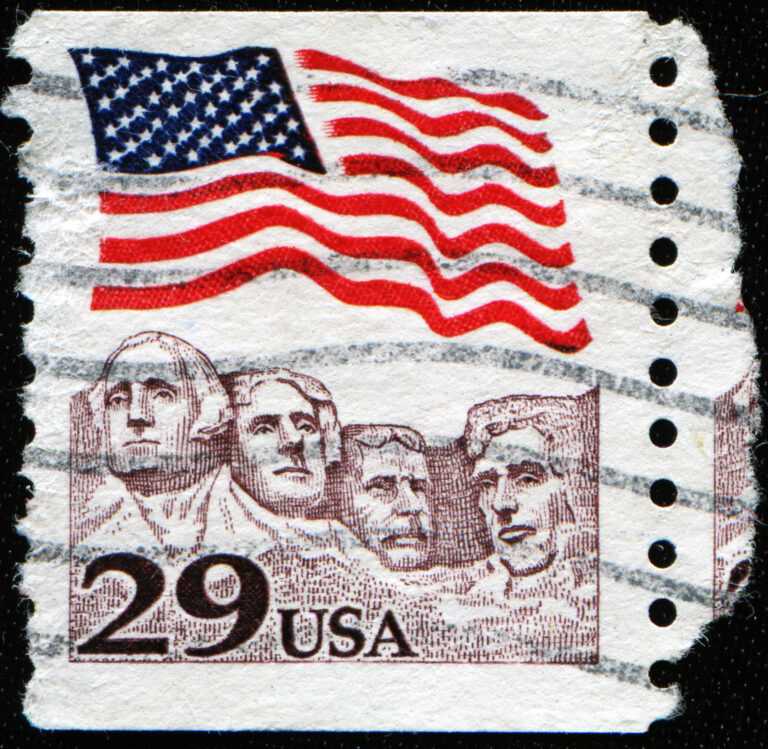 UNITED STATES OF AMERICA - CIRCA 1991: A stamp printed in the USA shows American flag waving proudly above Mt. Rushmore, circa 1991