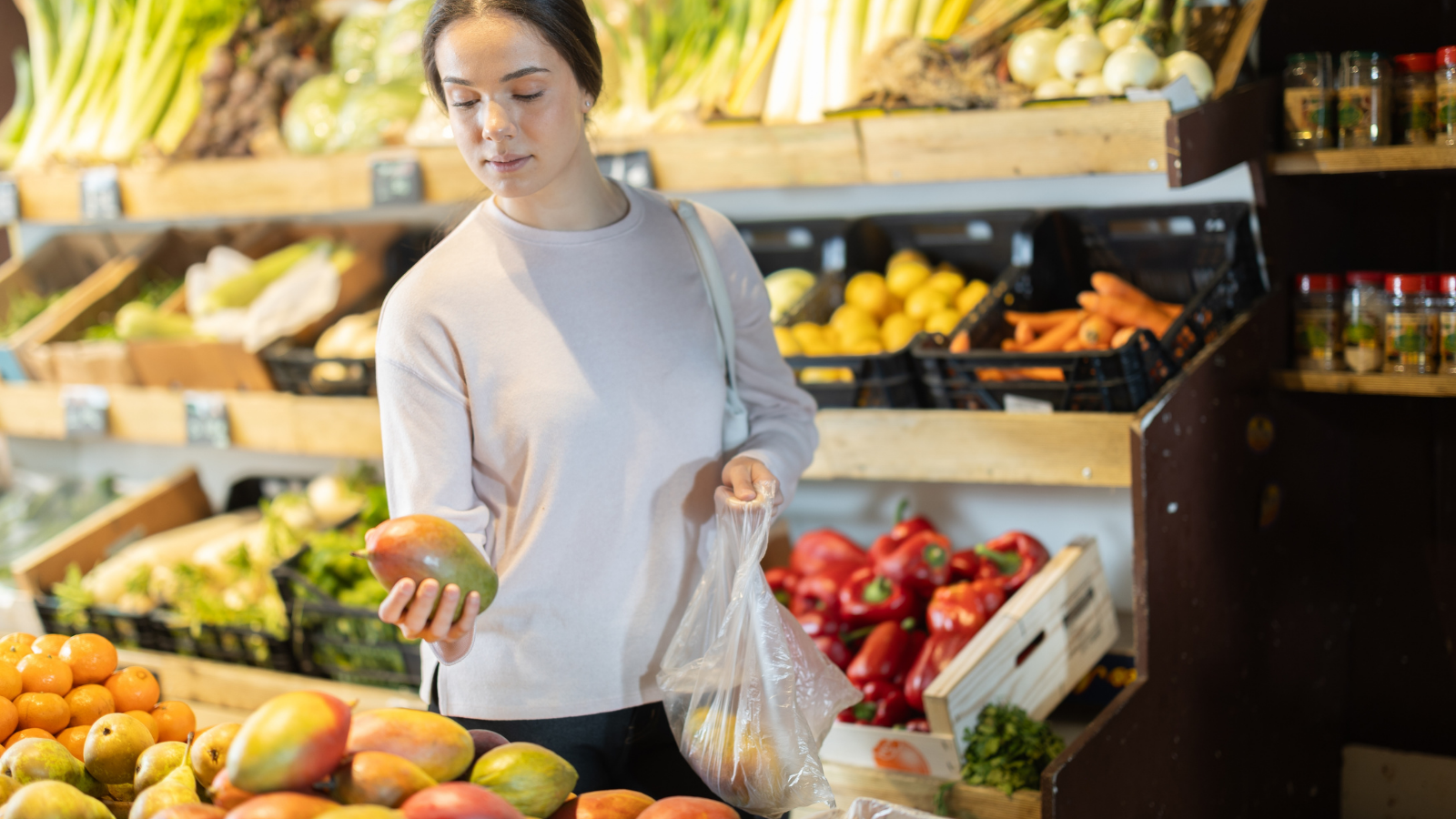 woman buyer choosing fresh mango
