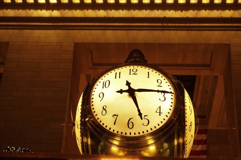 An antique clock at Grand Central Station, New York City, glowing warmly.
