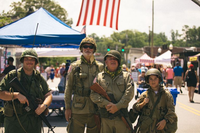 Group of veterans in military uniforms celebrating Independence Day at a parade in Brevard, NC.