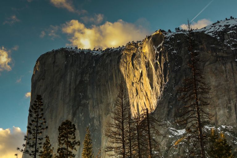 Stunning view of El Capitan illuminated by golden sunlight in Yosemite National Park.