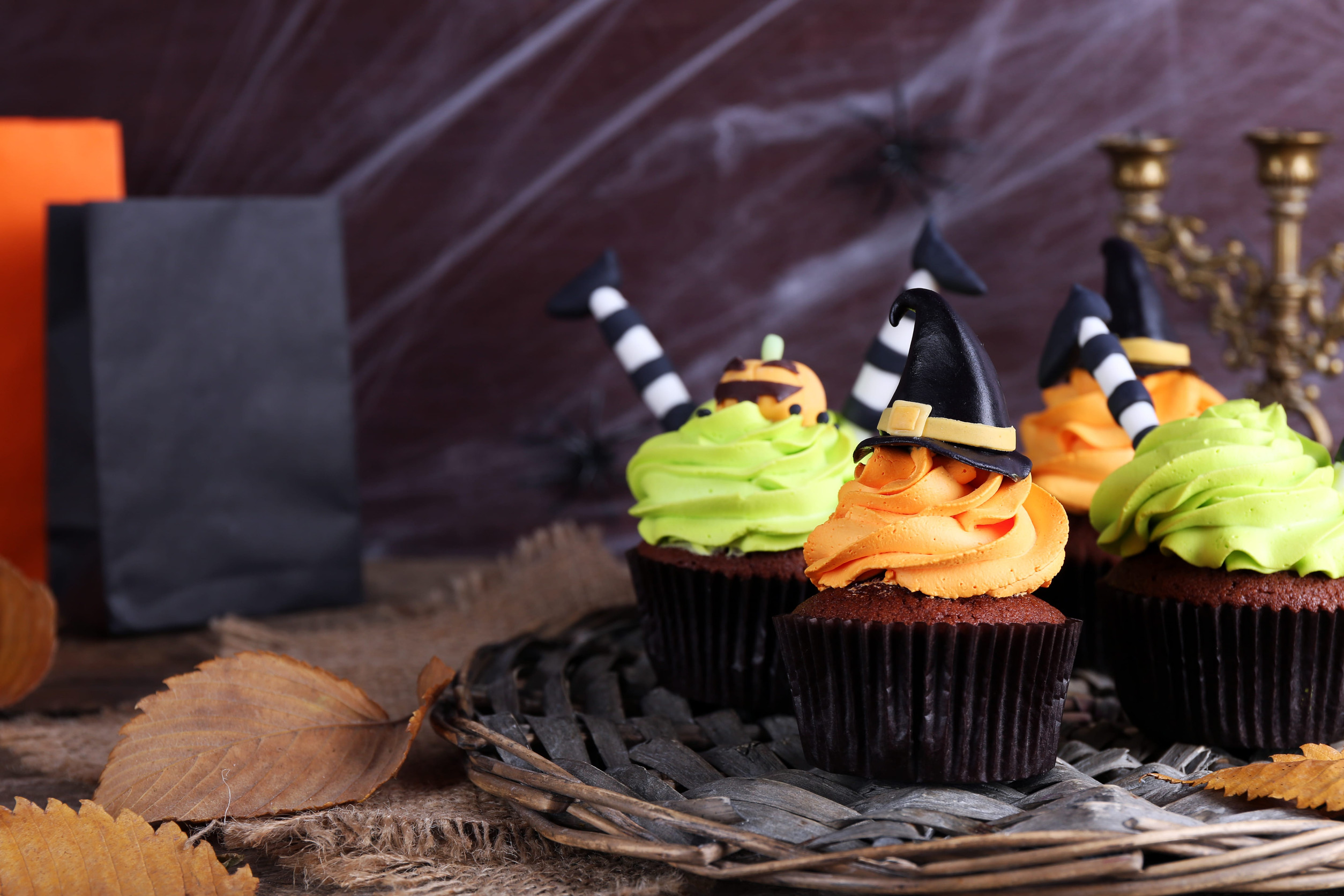 Halloween cupcakes on wicker mat on table