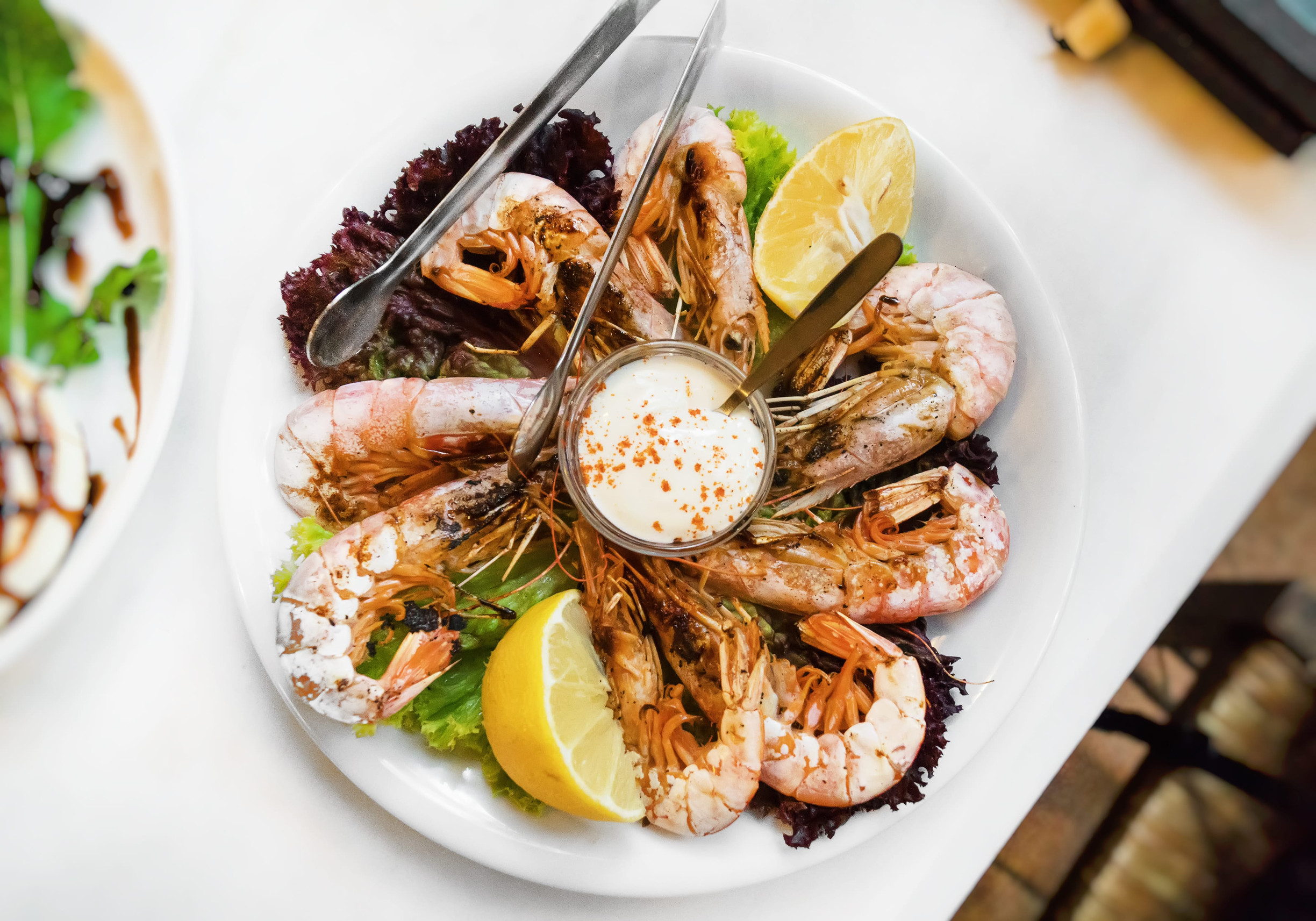 Grilled king prawns with mediterranean sauce.