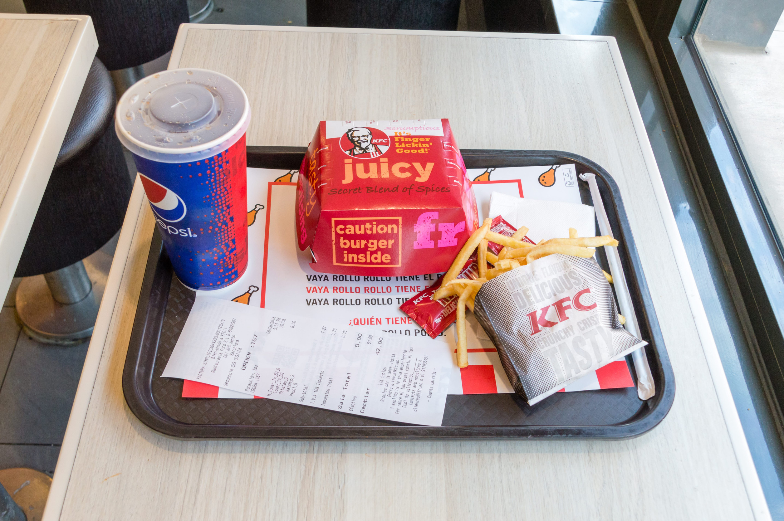 Barcelona, Spain - June 6, 2018: Restaurant Menu with Tower sandwich, Pepsi and french fries.