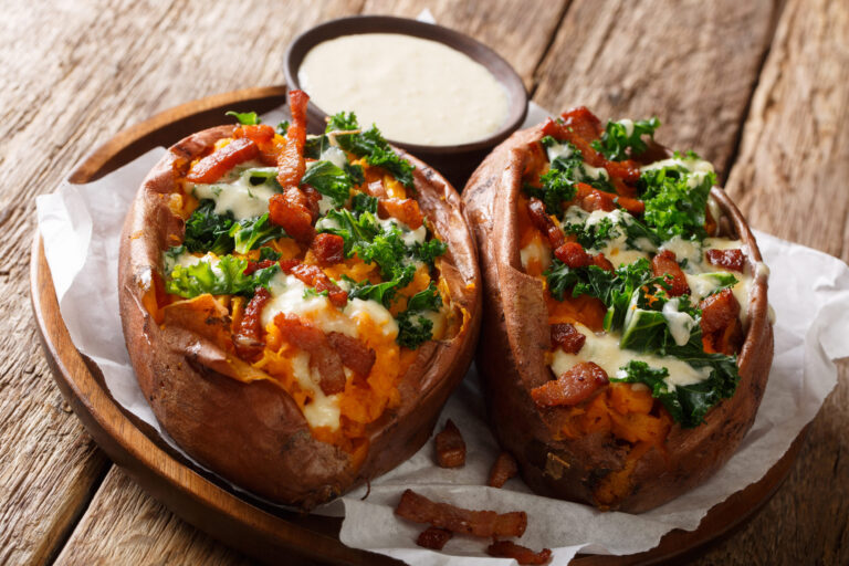 Homemade rich baked sweet potato with kale, bacon and cheese sauce. Image Credit: lenyvavsha/ 123RF