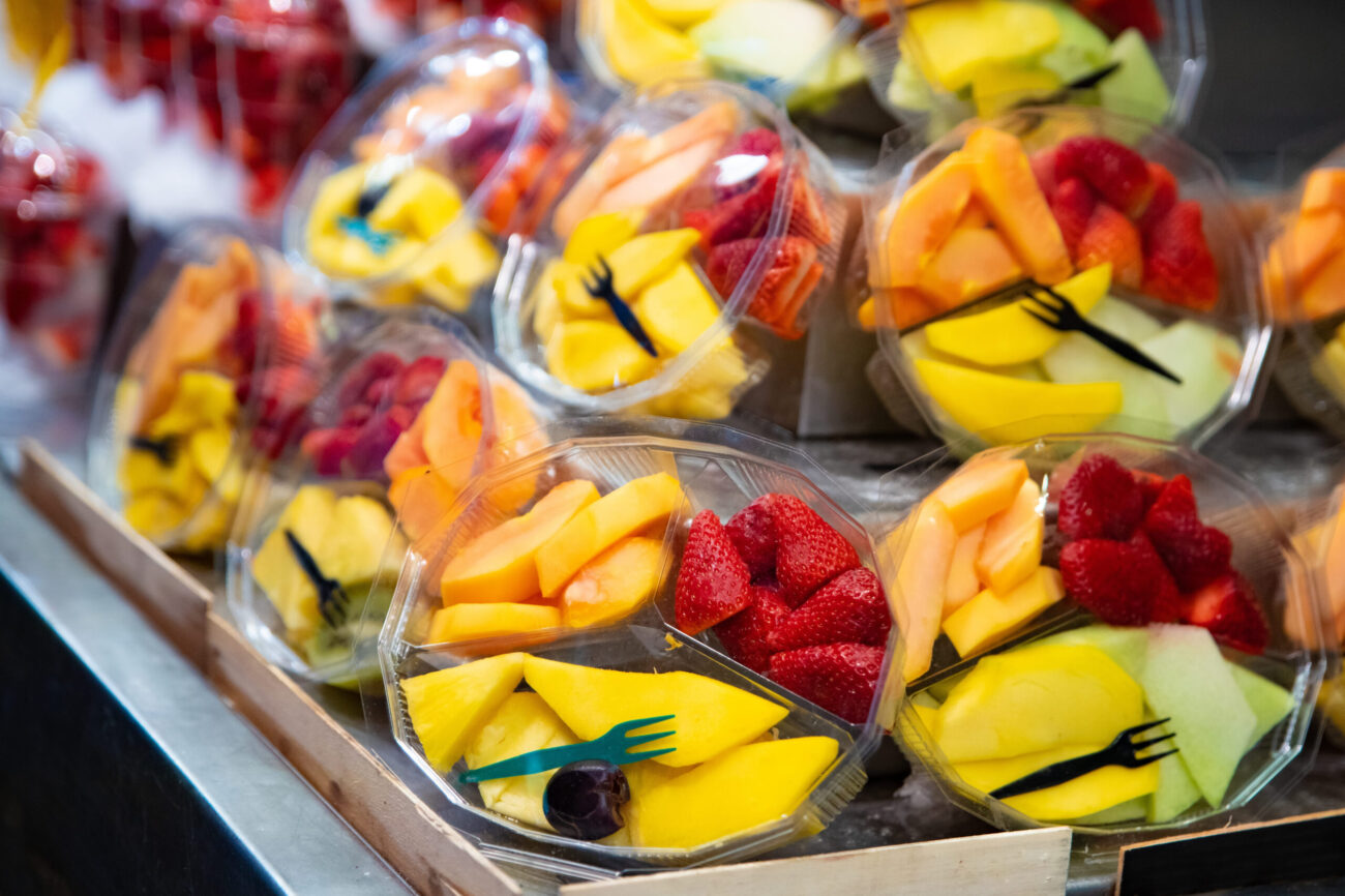 A vibrant display of freshly cut fruit salads, showcasing an assortment of juicy melons, strawberries, and tropical delights, perfect for a refreshing snack on a sunny day. Image Credit: djedzura/ 123RF