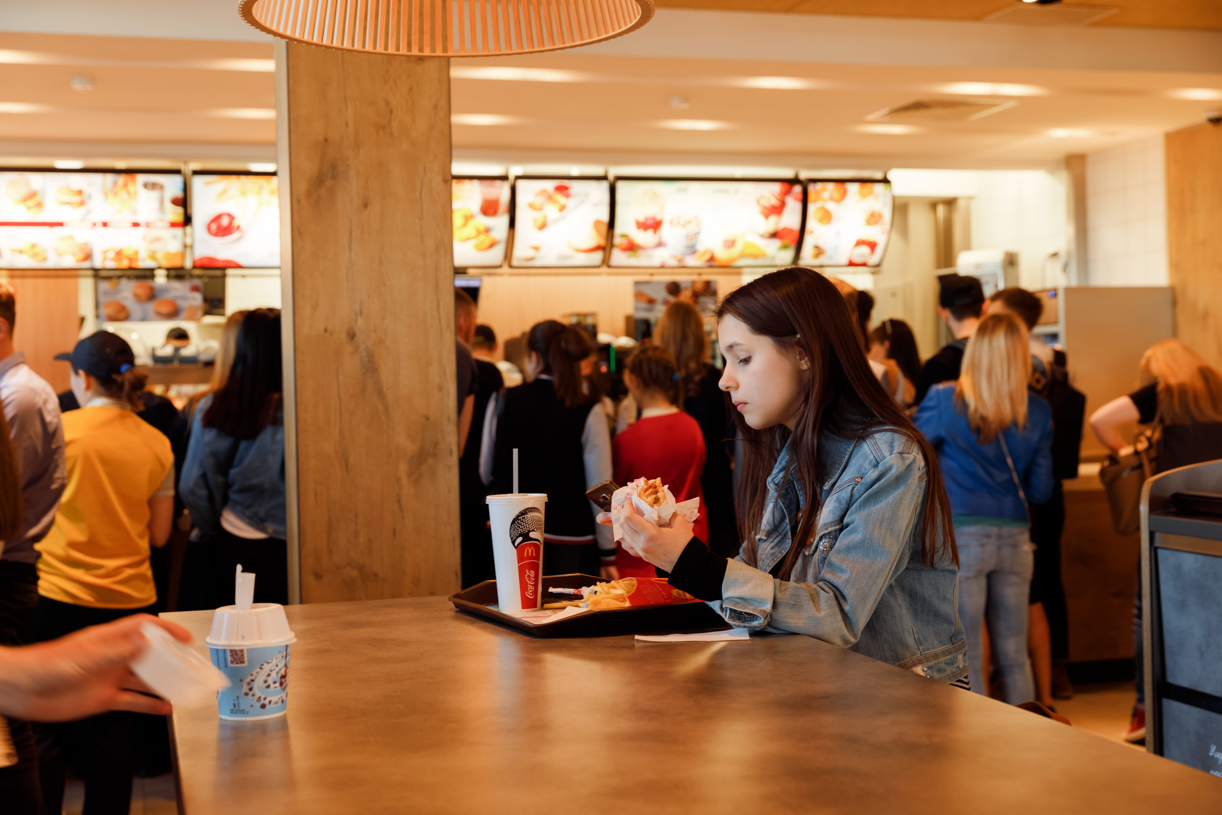 KYIV, UKRAINE - May 05, 2017: Young people have a rest and eating in a Mcdonald's in Kyiv, Ukraine. Mcdonald's is a very good place for young people. Illustrative editorial.