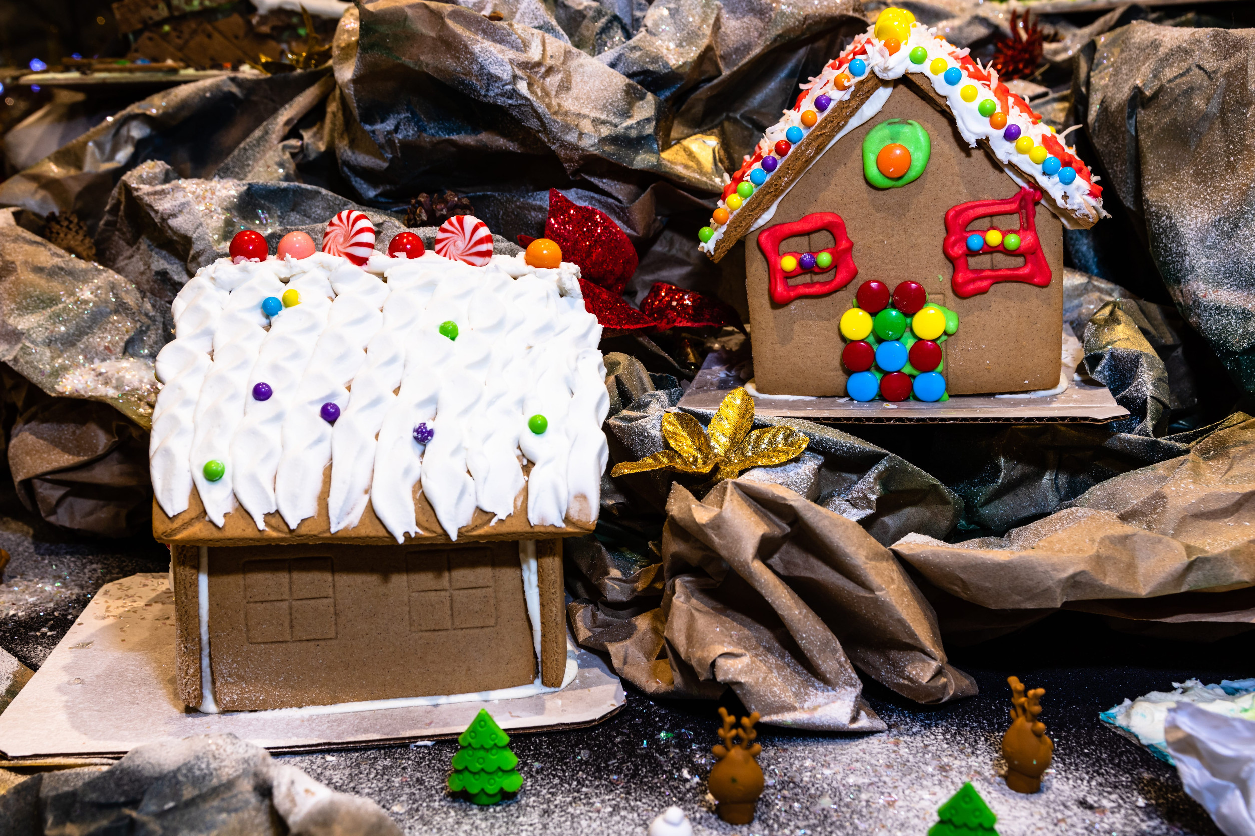 Christmas decorations against blurred background. Ginger houses with candies.