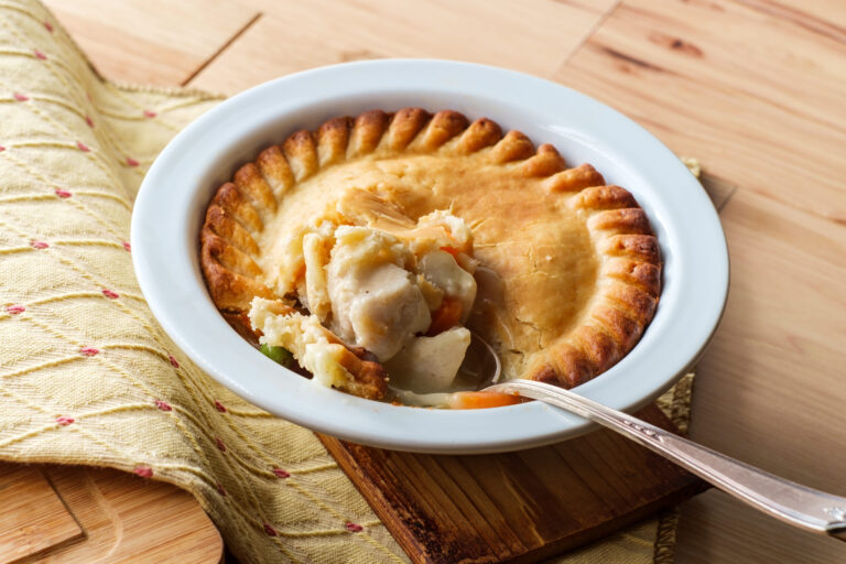 A delicious chicken pot pie, golden brown and bubbling with savory filling, invites you to take a bite. Nestled in a crisp crust, it's the perfect comfort food for a cozy evening at home. Image Credit: mackoflower/ 123RF