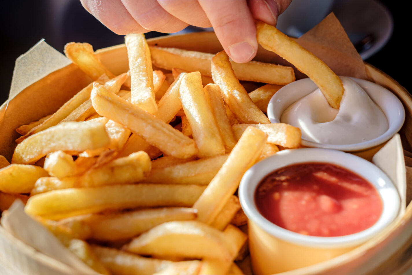 A delicious serving of crispy golden fries, invitingly arranged, with a side of rich ketchup and creamy mayonnaise, perfect for sharing or indulging solo. The aroma of fresh potatoes fills the air, promising a satisfying crunch with every bite. Image Credit: koldunova/ 123rf