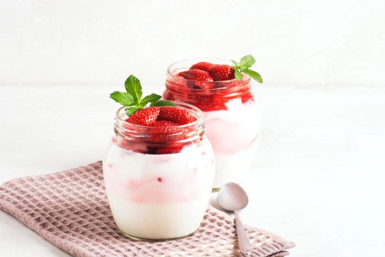 Delight in a refreshing treat with these creamy strawberry parfaits, layered with rich yogurt and topped with fresh strawberries and mint, perfect for any occasion. Image Credit: elenapro/ 123RF