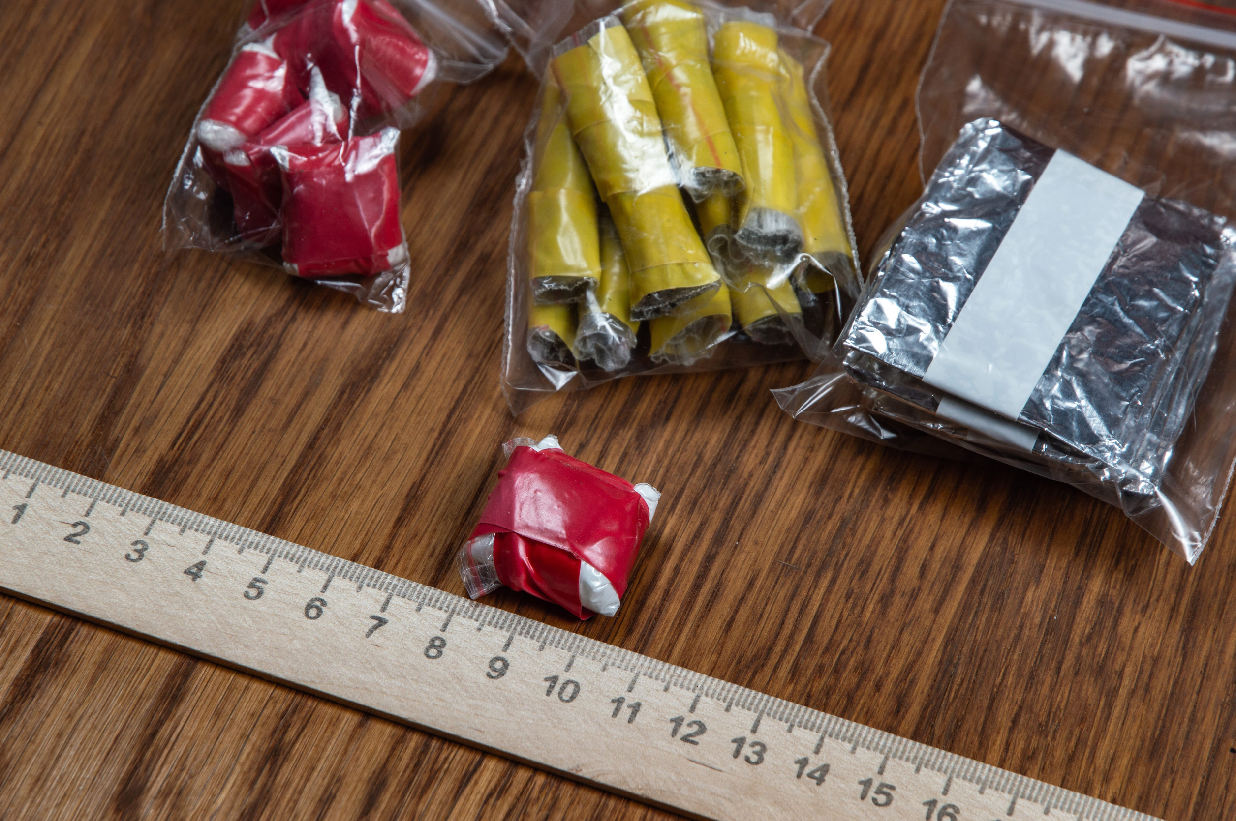evidence of smuggling traffic: packages of unknown drugs next to the forensic scale