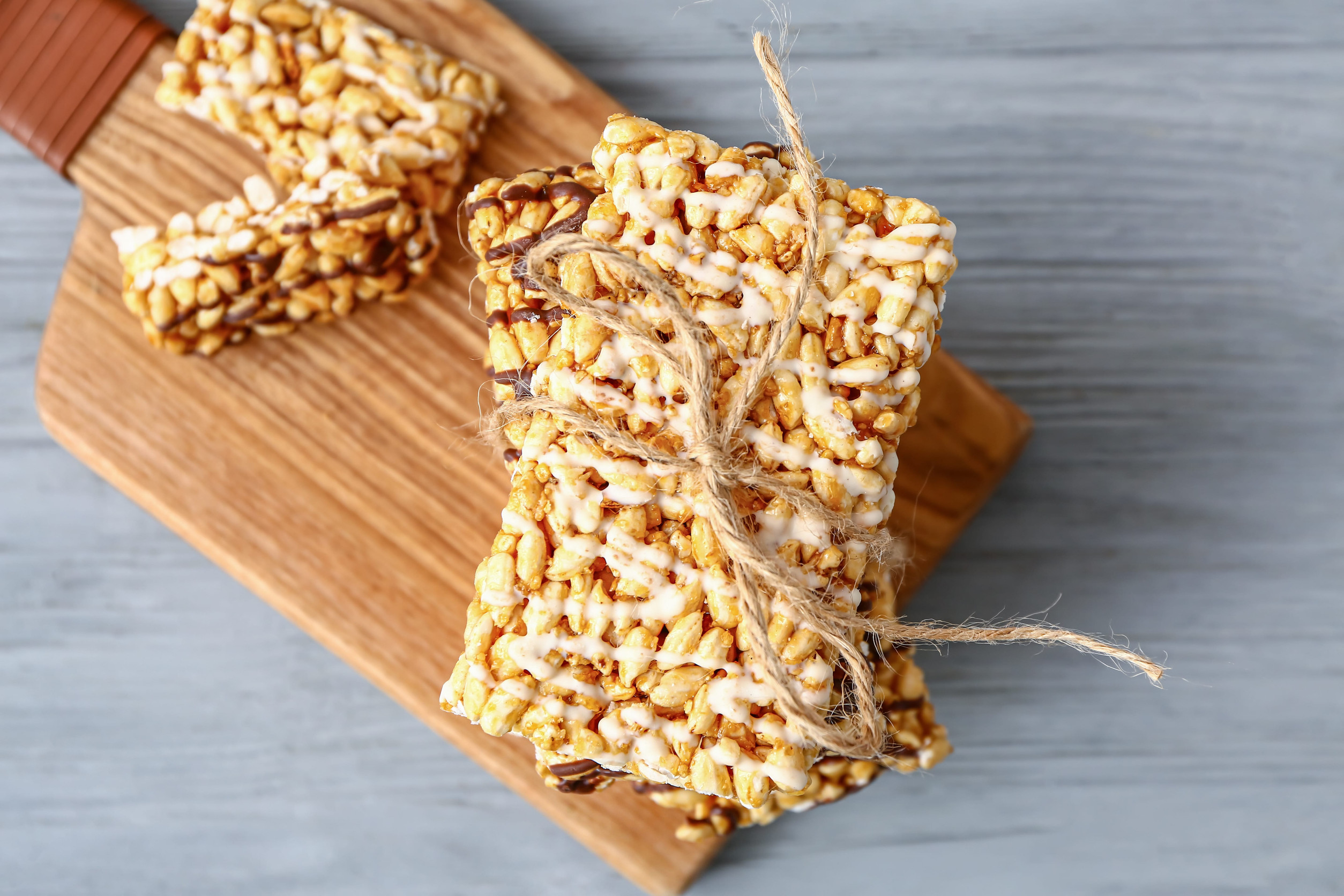 Board with crispy rice bars on table
