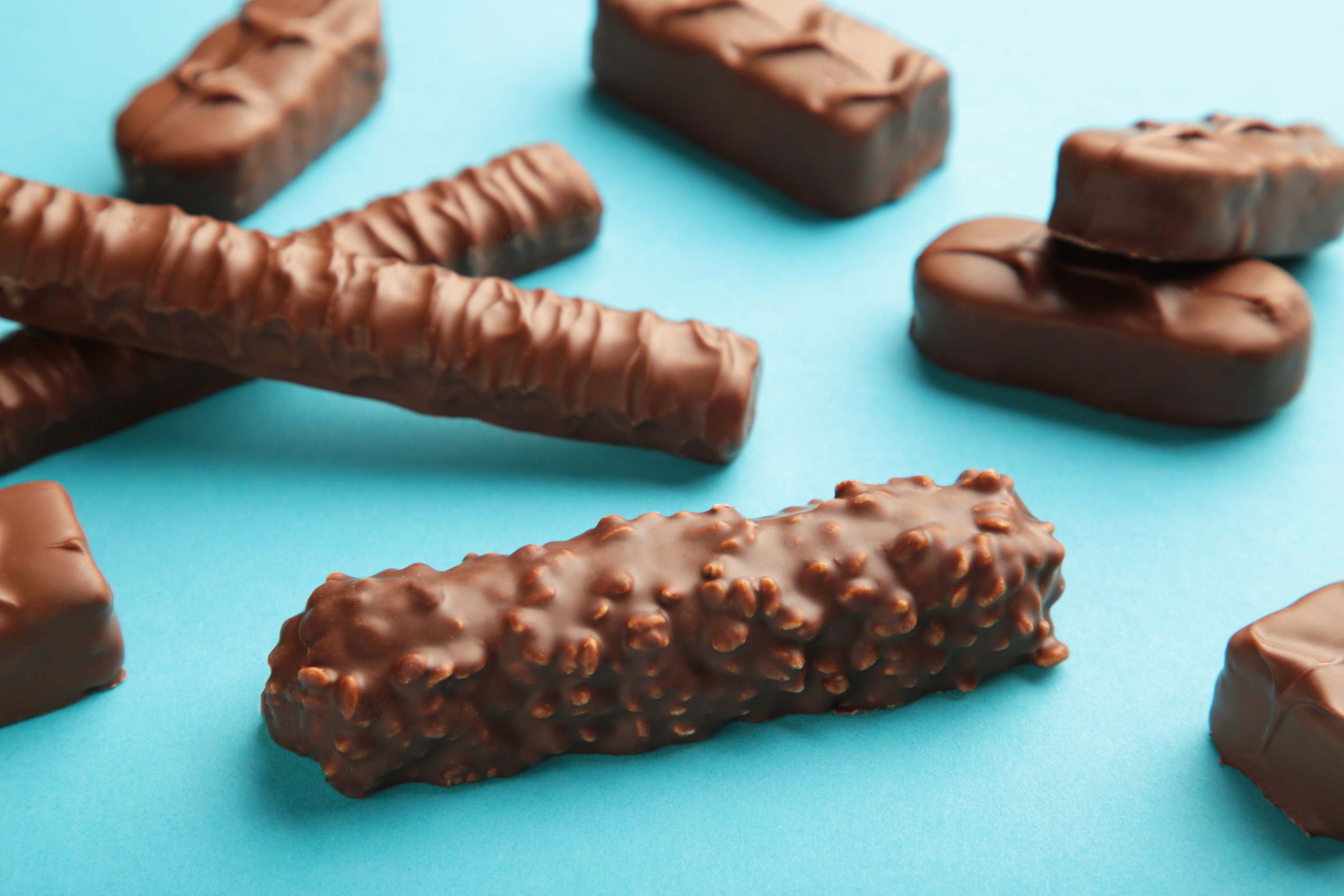 Mix of chocolate bars on blue background.