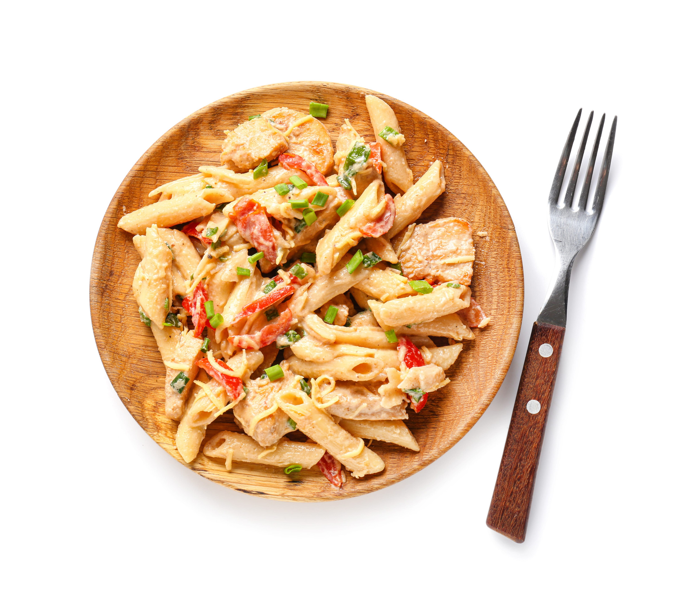 Plate with tasty cajun chicken pasta on white background