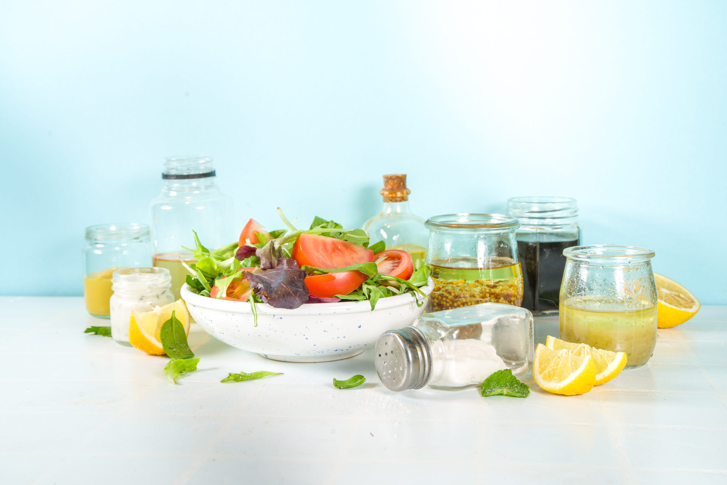 Healthy spring salad with various homemade dressings, salad sauces,