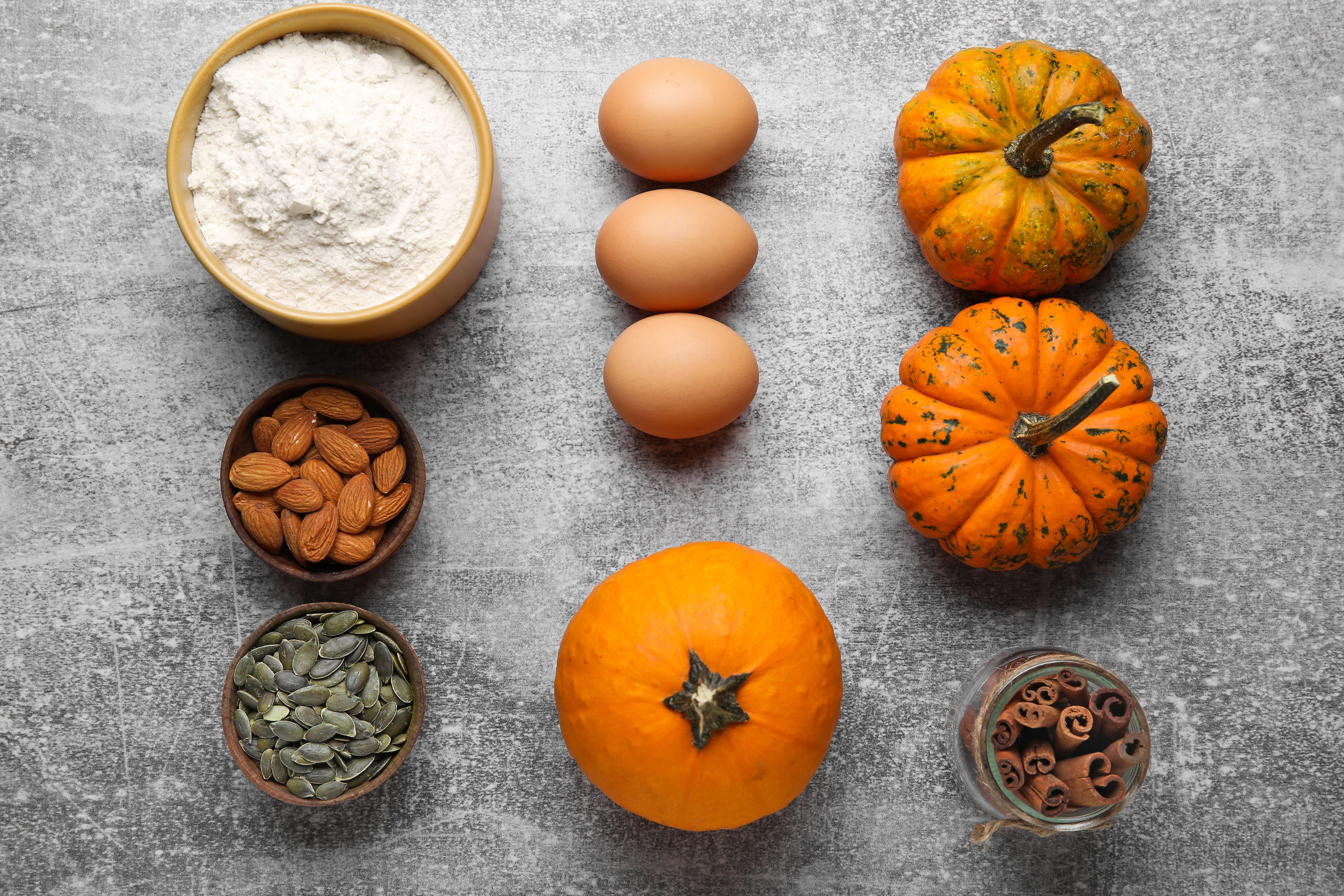 Ingredients for preparing pumpkin pie on gray background