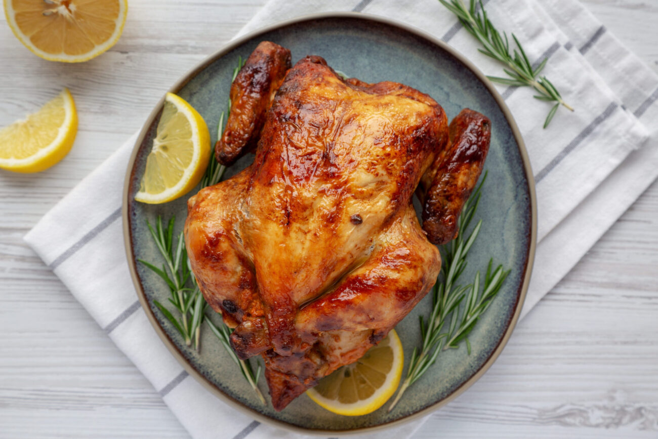 Homemade Lemon and Herb Rotisserie Chicken on a Plate. Image Credit: liudmylachuhunova/ 123RF