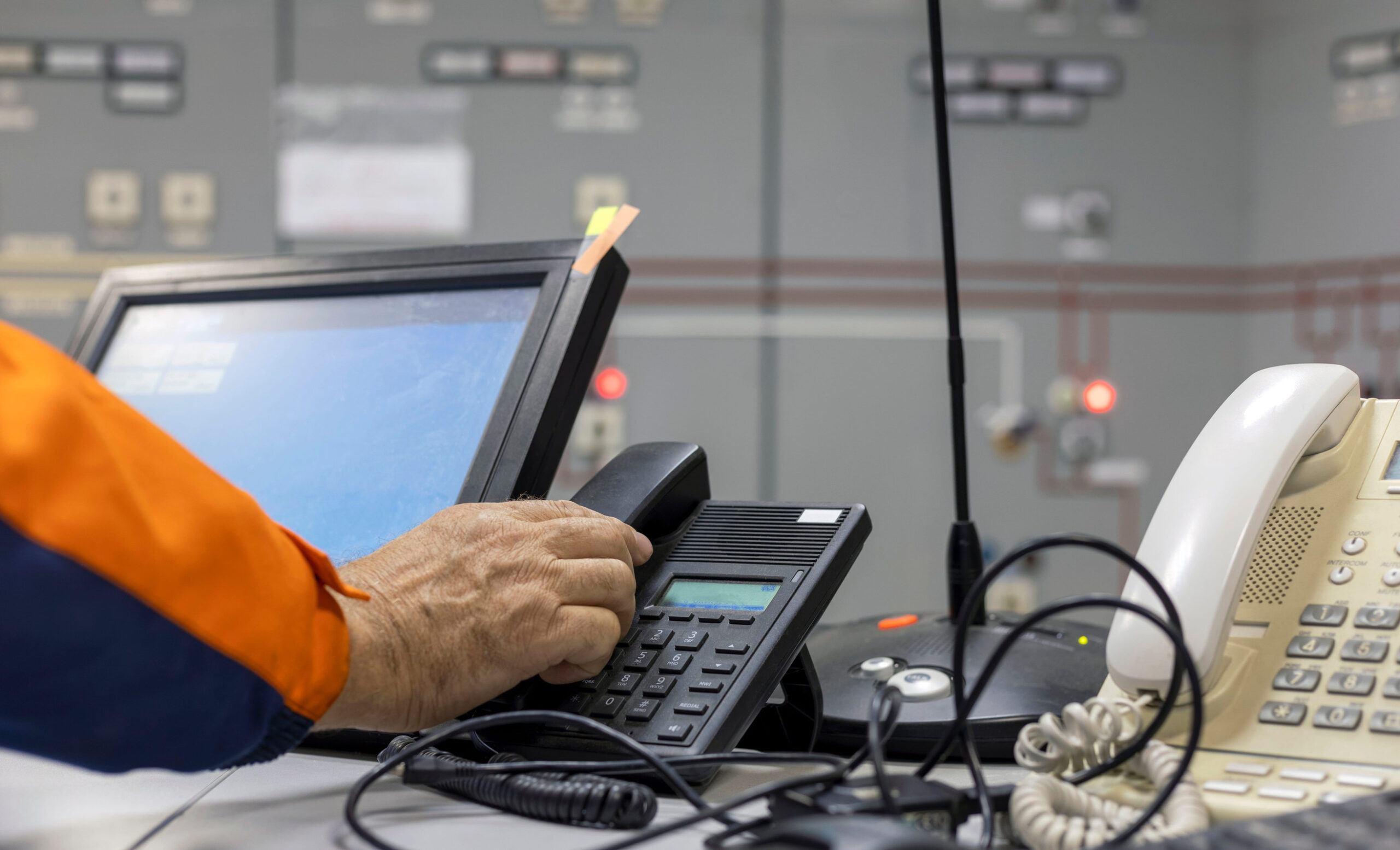 The operator works in the control room with the phone. selective focus.