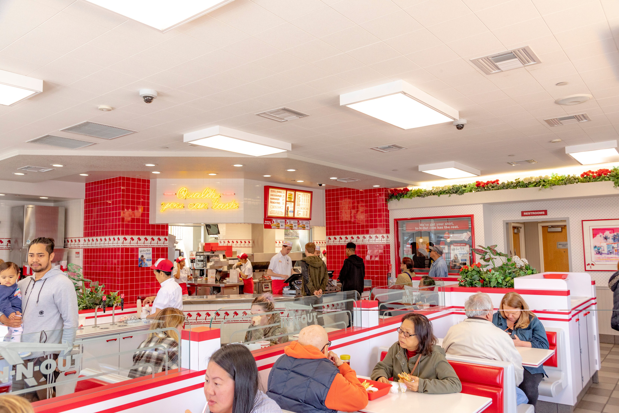 Daly City, USA - April 30, 2019: People enjoy burger at a fast food restaurant In-n-Out Burger.