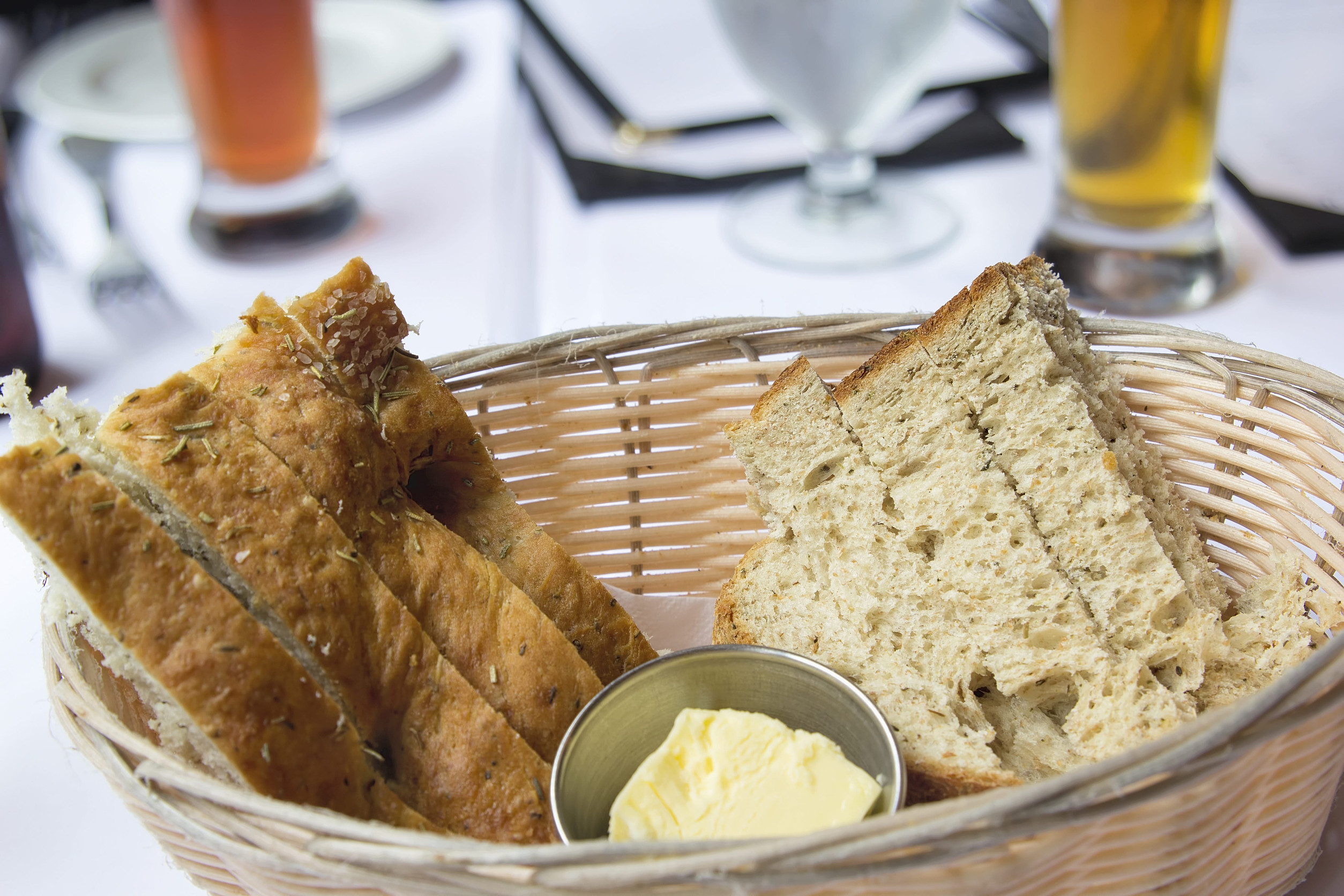 Sourdough Herb Bread with Butter in Basket Closeup