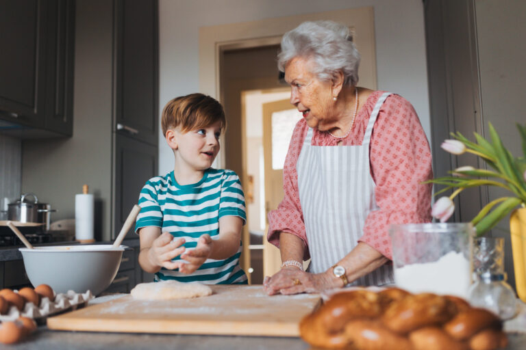 In a cozy kitchen, a young boy learns the art of baking from his grandmother. Their laughter fills the air as they work together, creating memories and delicious dough for their next family feast. Image Credit: halfpoint/ 123RF