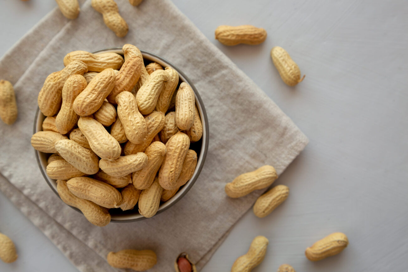 A delightful bowl brimming with roasted peanuts, perfect for snacking or adding crunch to your favorite dishes. Each bite transports you to a sunny afternoon, where taste meets nostalgia. Image Credit: liudmylachuhunova/ 123RF