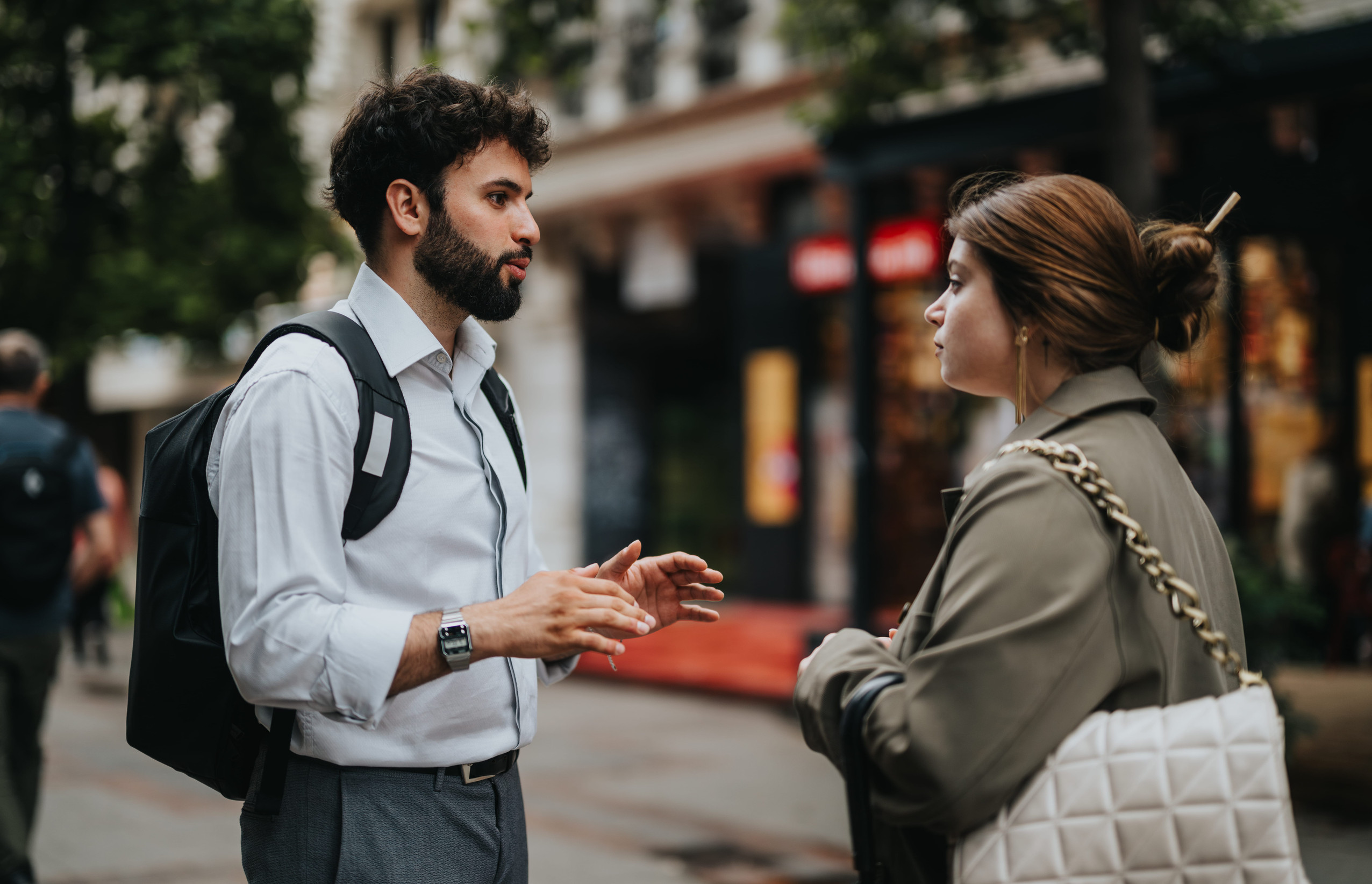 Businesspeople discussing ideas during an outdoor meeting in an urban setting