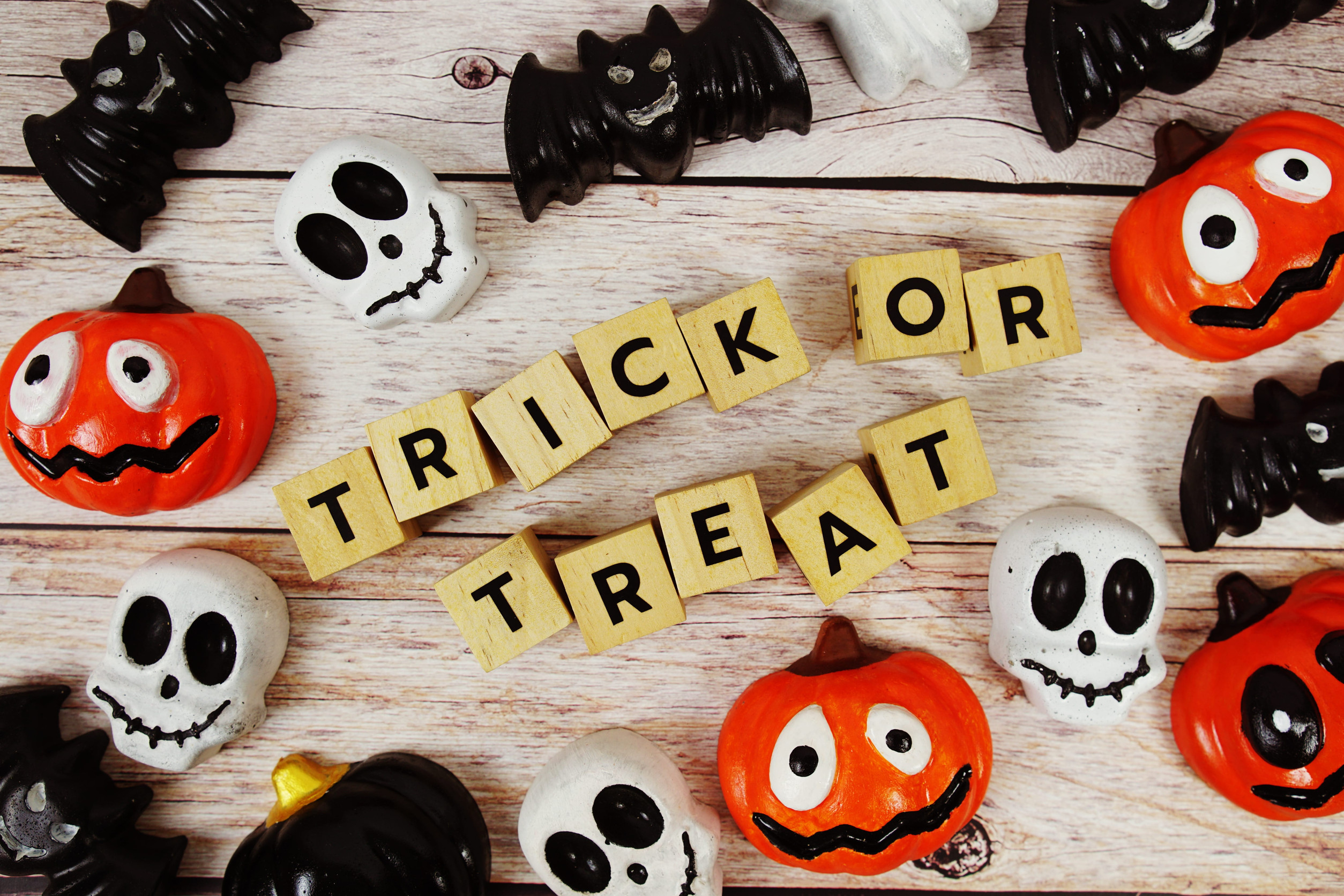 Trick or Treat alphabet letters with element decorations on orange background