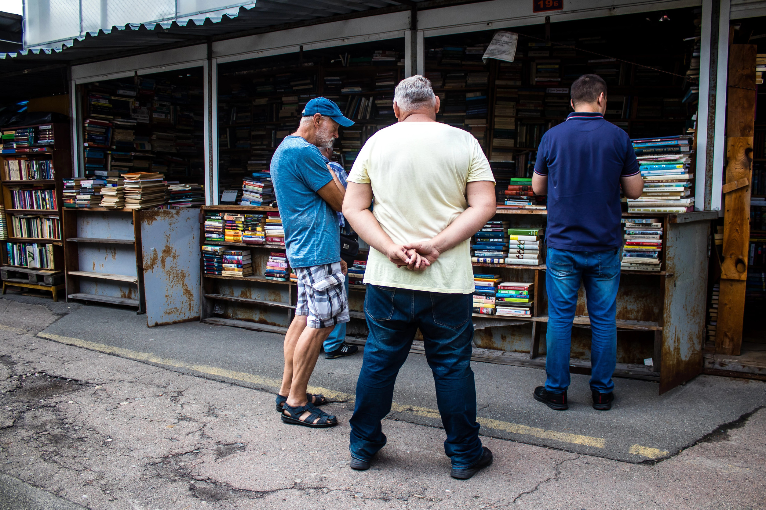 People shopping at book market Petrivka located in Kyiv, Ukraine. Famous for its great range of books. Sprawling open air market with stalls selling secondhand books. Despite the war and the fact that there are no tourists, this place remains very popular