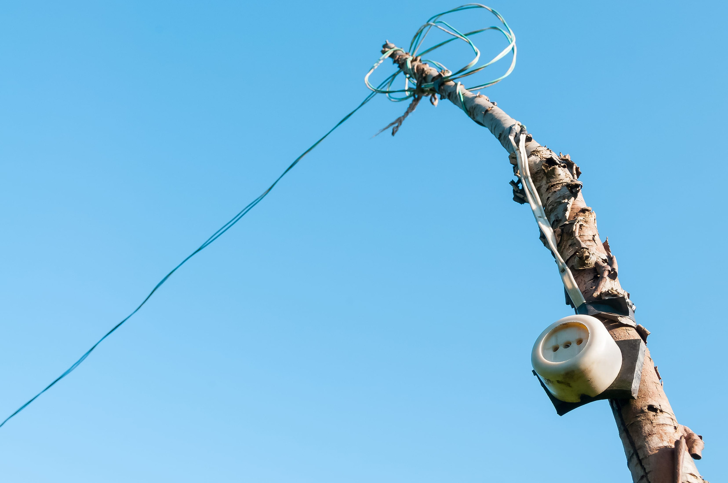 Old round socket on a pole, on sky background.