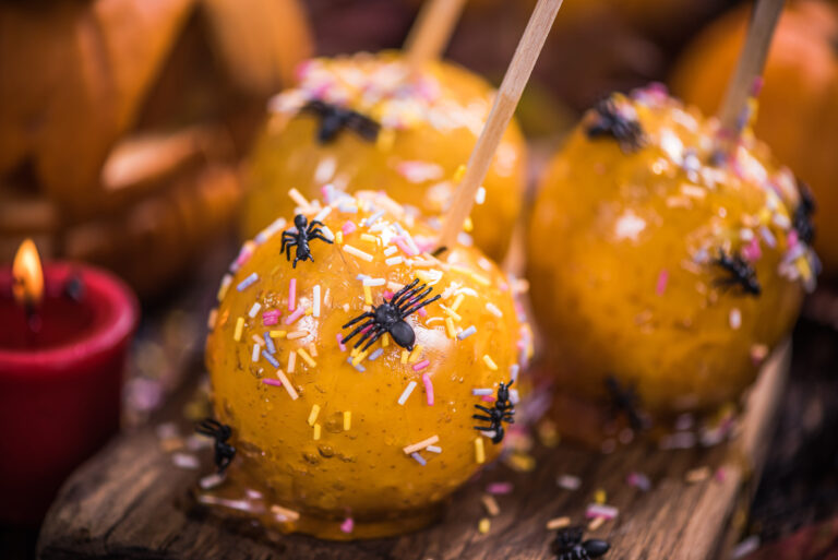 A spooky autumn delight, these caramel apples are dressed for Halloween with colorful sprinkles and tiny plastic spiders, offering a sweet yet eerie treat for the festivities. Image Credit: merc67/ 123RF