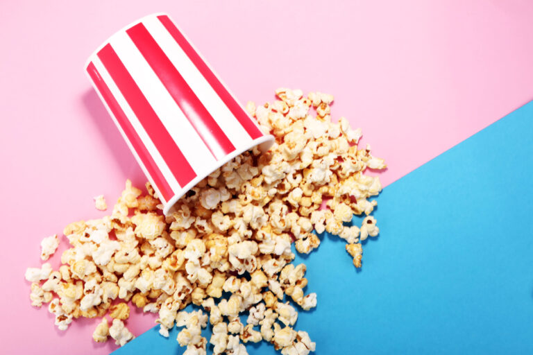 Salt popcorn or sweet popcorn flat lay on colored paper. Image Credit: beats1/ 123RF