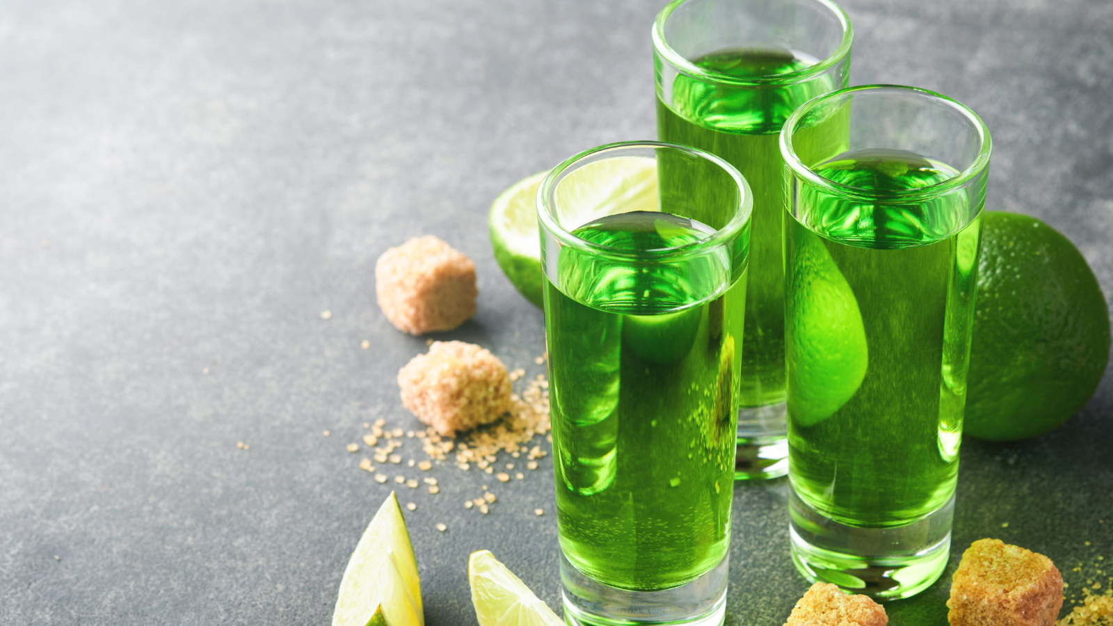 Two glasses of absinthe with cane sugar and lime on dark background. Strong alcoholic drink. Image Credit:
kasia2003/ 123RF