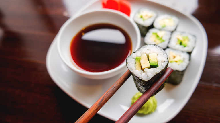 A delightful sushi platter featuring vibrant rolls, a small bowl of soy sauce, and a dollop of wasabi, perfect for a culinary adventure. Each bite promises a burst of freshness and flavor, making it an irresistible choice for sushi lovers. Image Credit: aksenovko/ 123RF