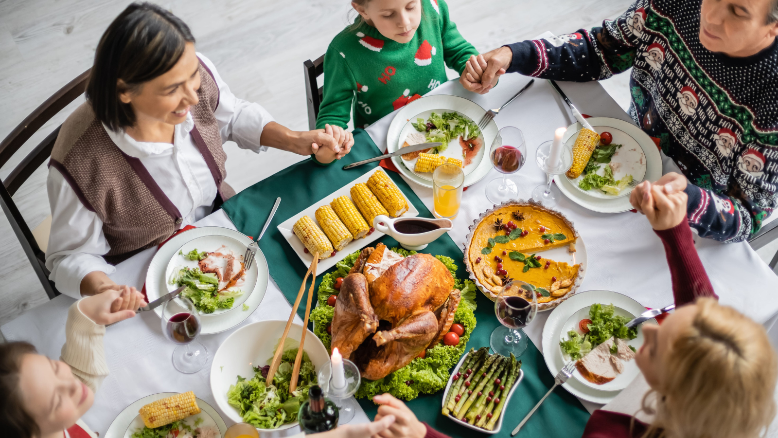 Gathered around the table, a joyful family shares a festive meal, filled with heartwarming conversation and delicious dishes, as laughter fills the air and memories are made. Image Credit: lightfieldstudios/ 123RF
