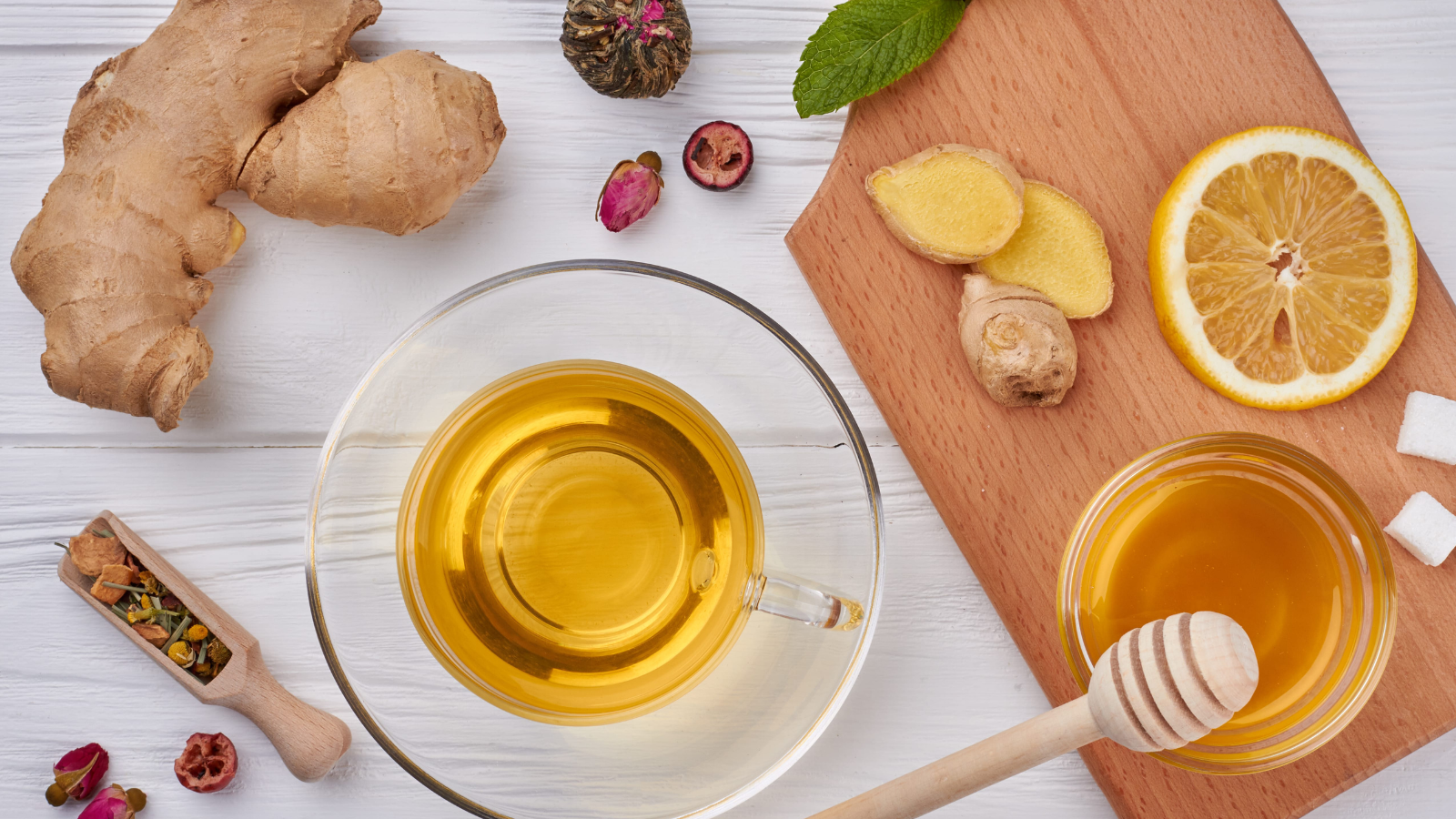 A cozy herbal tea setup featuring fresh ginger, honey, and vibrant lemon, perfect for warming up on a chilly day. Indulge in the comforting aroma and health benefits of nature's best ingredients. Image Credit: denisfilm/ 123RF