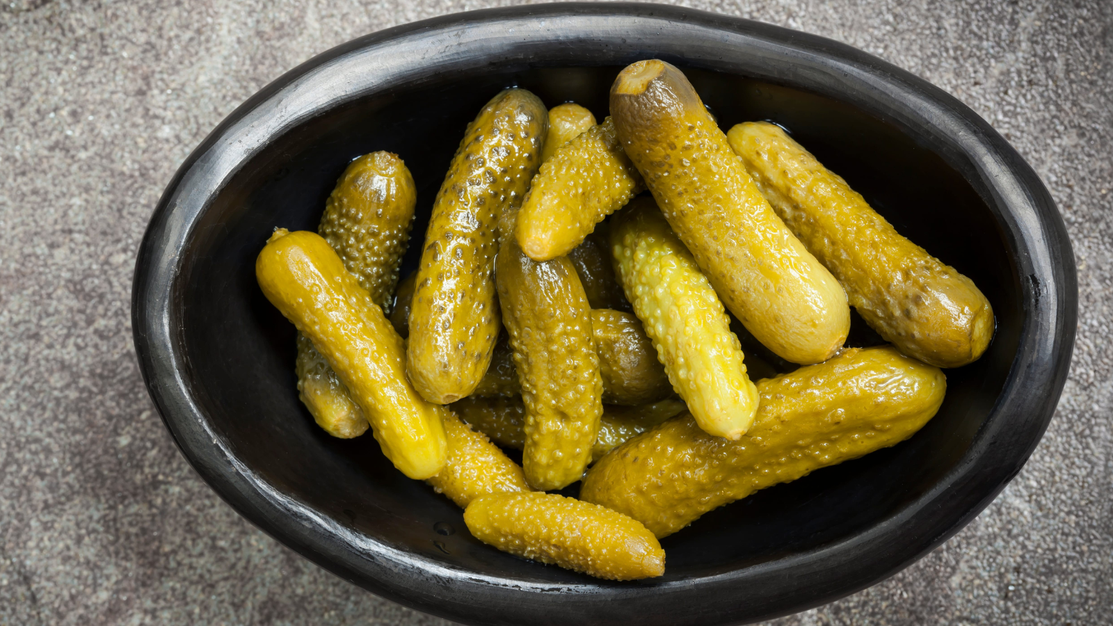 A rustic bowl filled with vibrant pickles, showcasing a variety of textures and hues that add zest to any culinary creation. Perfect for garnishing dishes, these pickles evoke a sense of homemade charm and culinary delight. Image Credit:
robynmac/ 123RF