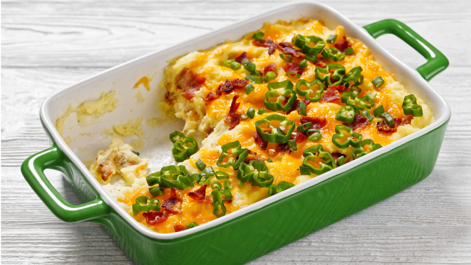 A deliciously creamy potato casserole with crispy bacon and melted cheese, garnished with vibrant green onions, perfect for a cozy family dinner. Image Credit: myviewpoint/ 123RF