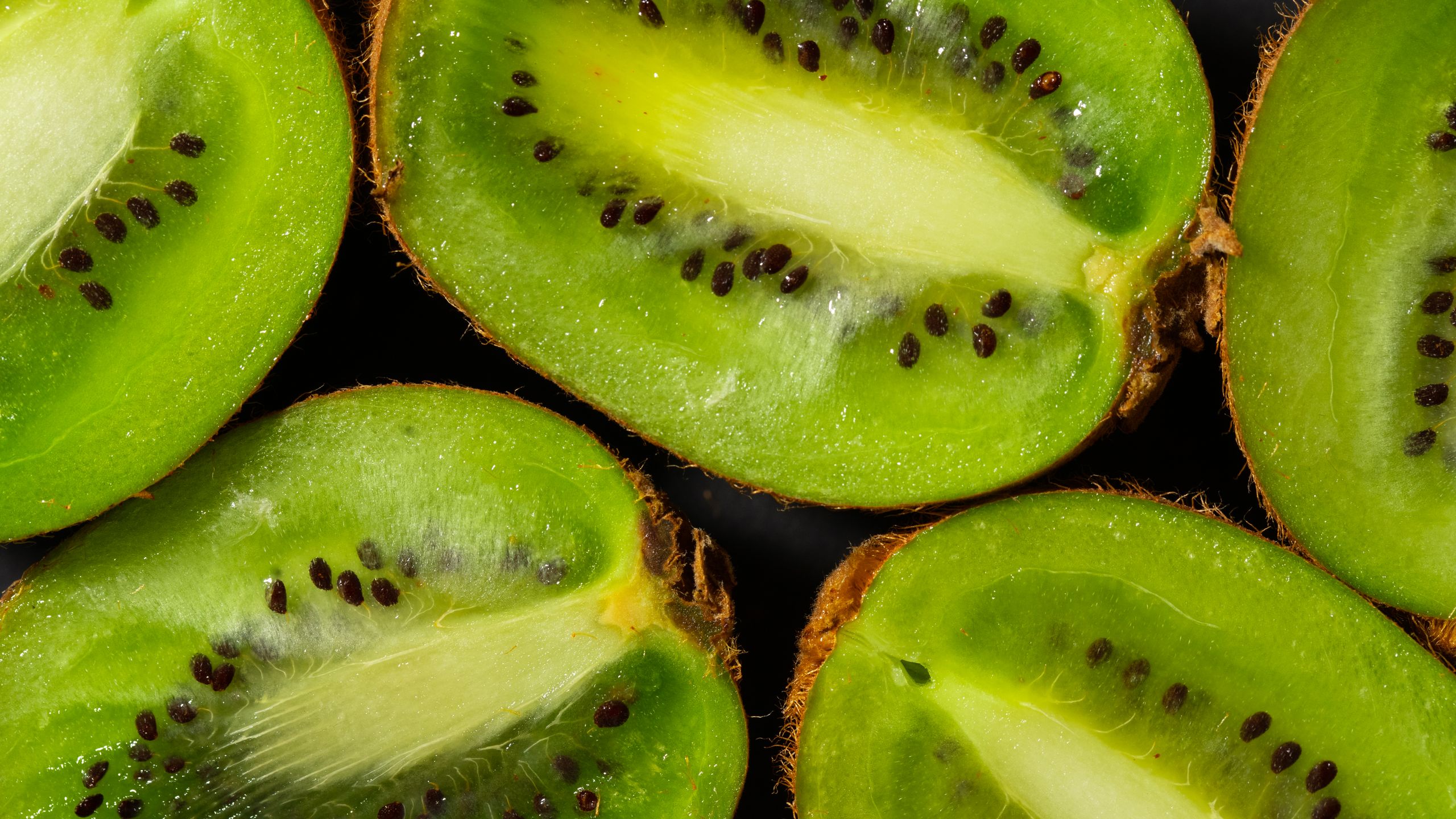 A detailed close-up of juicy kiwi slices showcasing fresh texture and seeds.