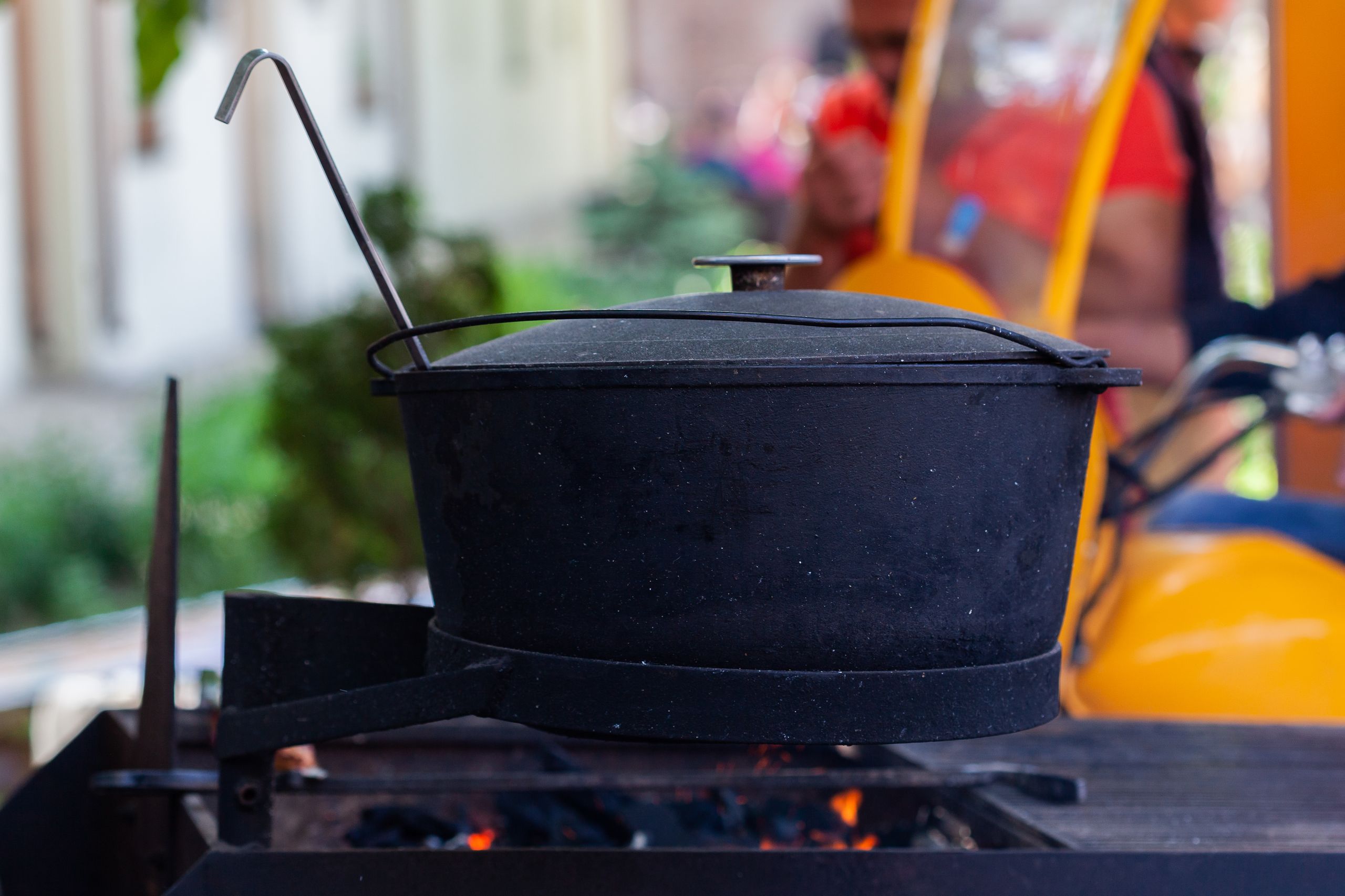 A large black pot on an open flame, perfect for outdoor cooking or camping scenes.