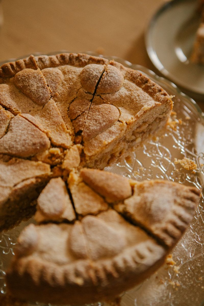 A rustic homemade apple pie with a decorative crust, perfect for autumn celebrations.