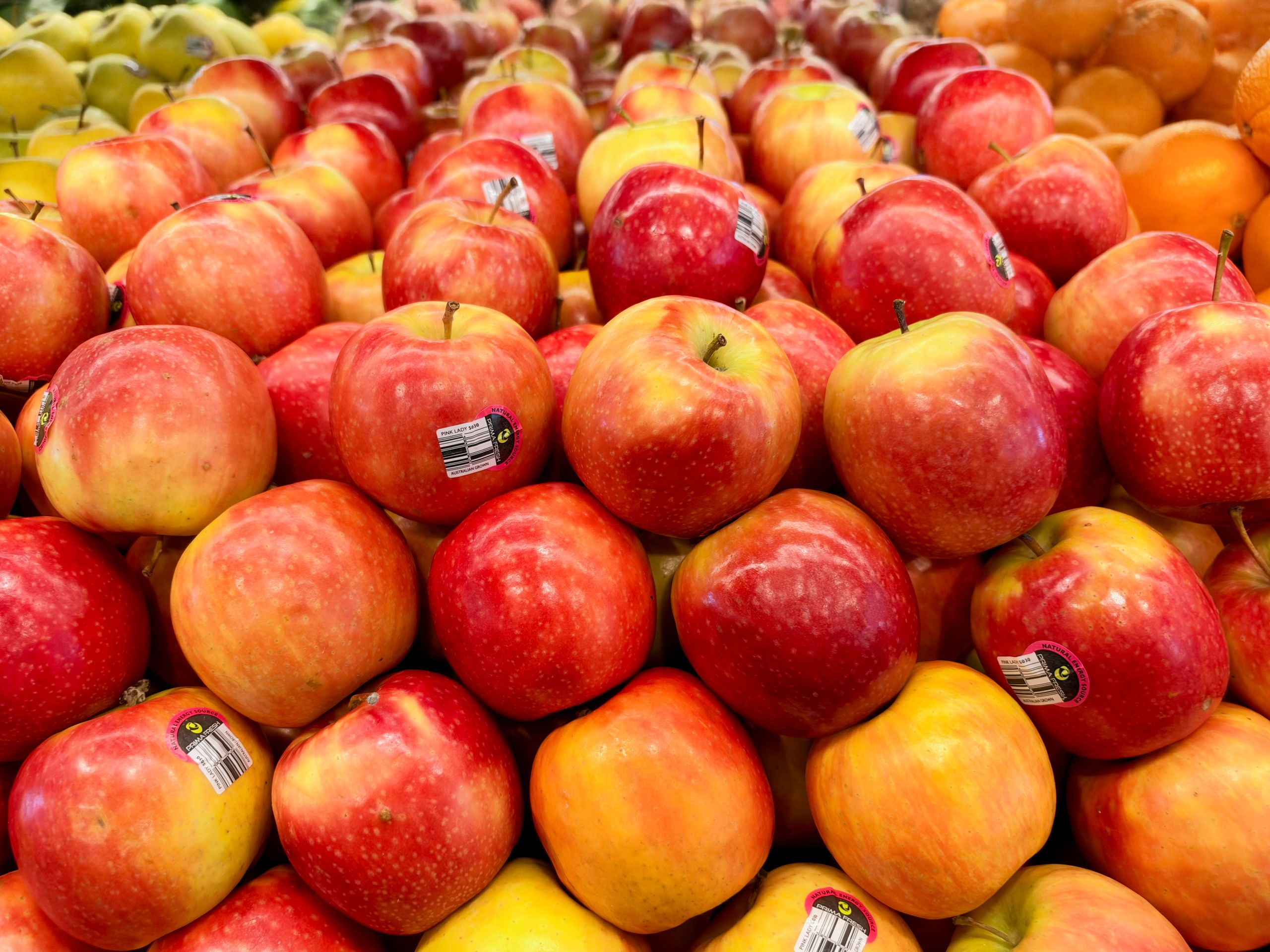 A vibrant array of fresh red apples stacked neatly in a market in Tarneit, Victoria.