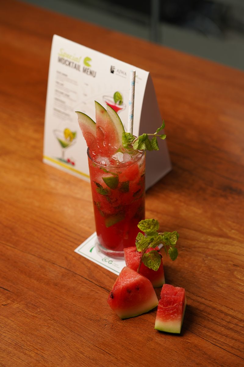 A vibrant watermelon cocktail garnished with mint leaves, perfect for summer refreshment.