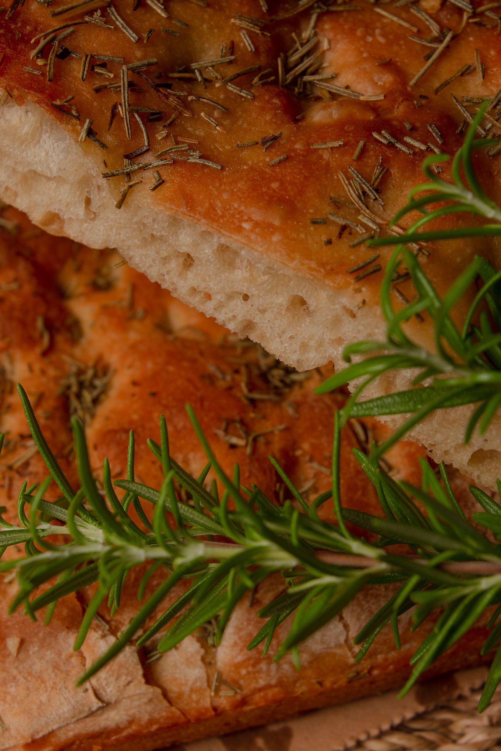 Appetizing focaccia bread topped with rosemary and herbs, perfect for culinary uses.