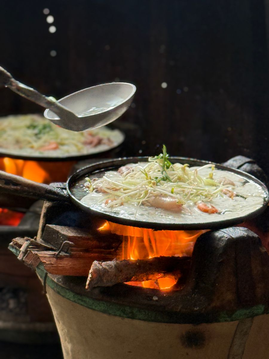 Authentic Vietnamese pancakes sizzling on clay stoves, showcasing traditional cooking methods.